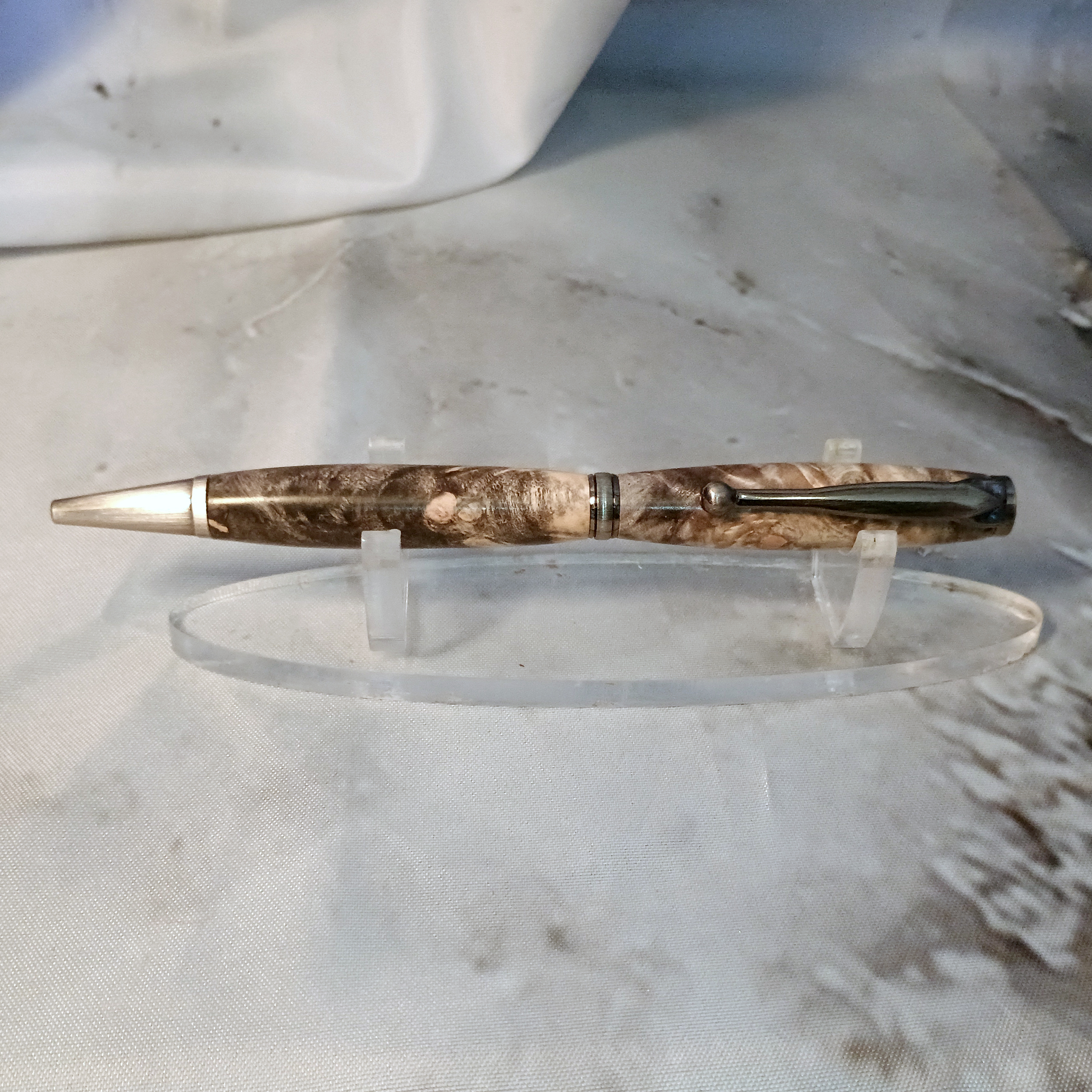 Slimline fancy pen in buckeye burl (BEB) with dramatic figure and antique gunmetal ornate hardware, showcasing spectacular wood character with Victorian details.