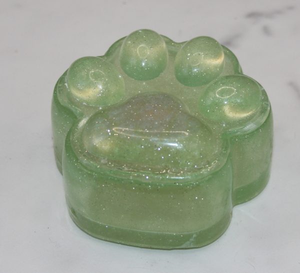 transparent sparkly green trinket box shaped like a paw print