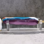 Compact perfume pen with rainbow iridescent finish, offering portable fragrance storage in a beautiful hand-turned design perfect for purse or pocket.