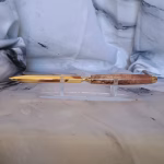 Gold letter opener with stabilized koa handle—tiger-stripe pattern preserved in resin finish