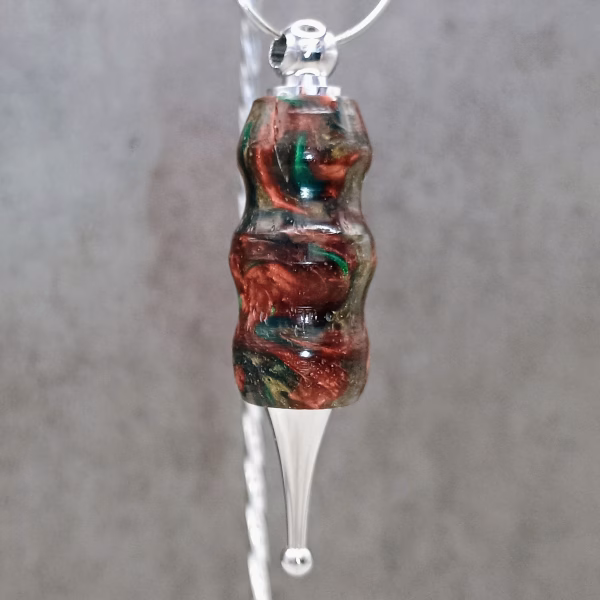 Satin chrome ornament with red, green, and gold resin – festive color palette in polished finish