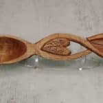 Hand crafted wooden spoon. The handle is an infinity symbol with hearts. Inside the hearts are the drop flowers from the bleeding heart plant.