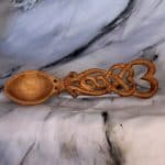 Hand carved Welsh love spoon with oval bow and a handle with open work consisting of two interlocked hearts and an infinity symbol
