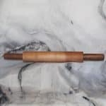 Maple & Walnut Rolling Pin: Side view of a hand-turned maple and walnut ball bearing rolling pin on a marble surface, maple walnut ball bearing rolling pin handcrafted by Sarkanys Rising