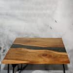 Top view of Italian olive wood live edge table showing dramatic grain figure and green resin river inlay