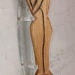 Hand carved spoon with a handle that is a couple in an intimate embrace.