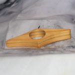 Small handcrafted wood page holder with rounded thumb opening and tapered diamond shape, made from reclaimed scrap wood — Sarkanys Rising