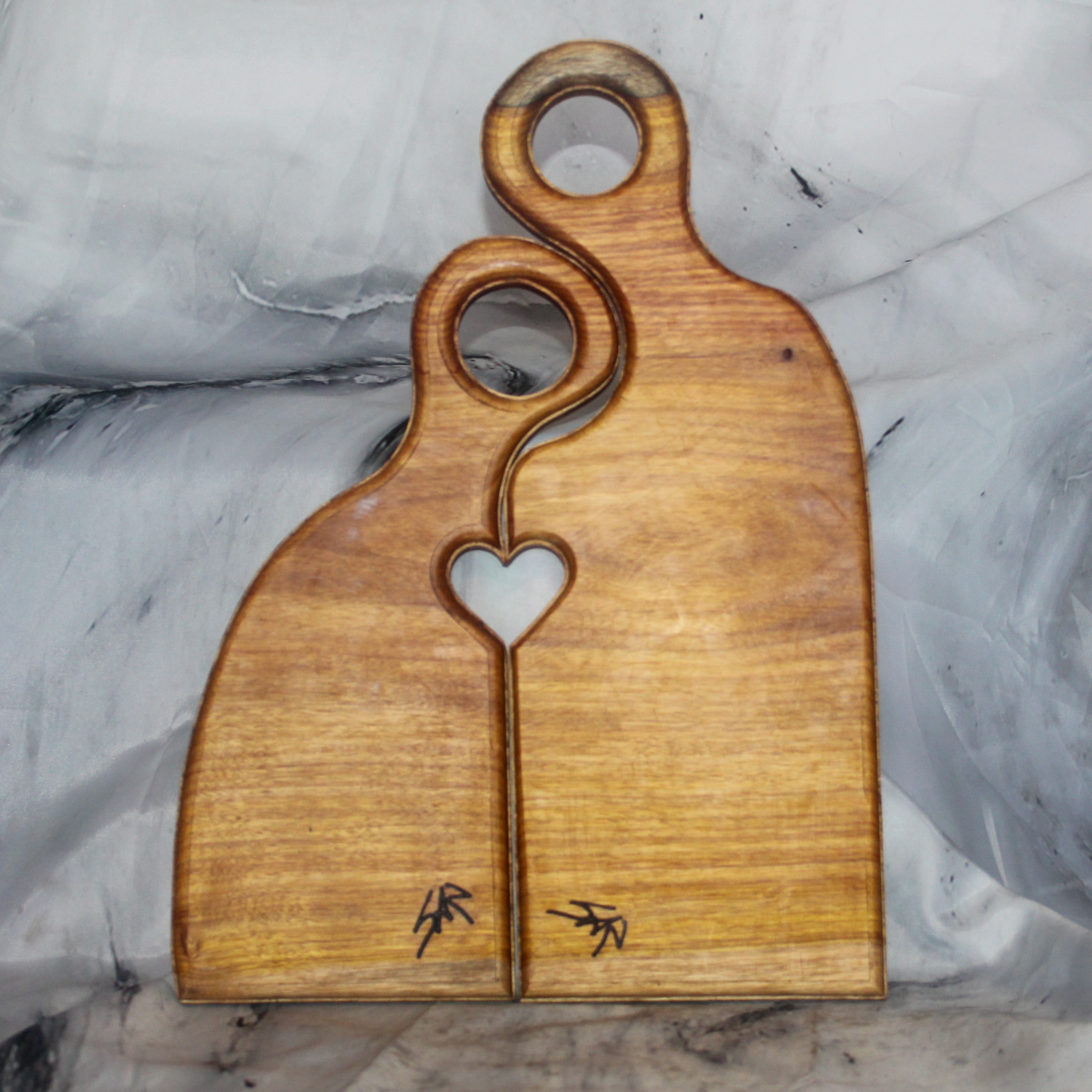 Back view of a canary wood Romeo and Juliet cutting board set showing maker's marks and interlocking design, handcrafted canary wood Romeo Juliet cutting board by Sarkanys Rising
