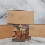 Long mystery pen blank boxes shown with one box emptied to display the variety and quantity of hardwood pen blanks included